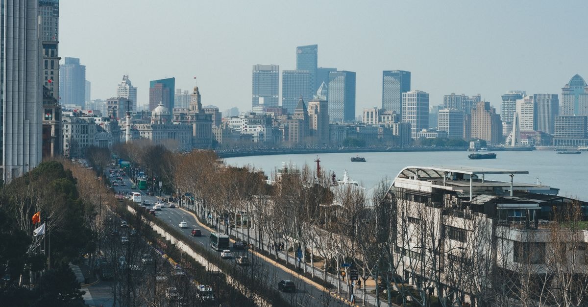 24K International Hotels in Shanghai: Nanjing Road Pedestrian Street Address Aerial view of Shanghai's Pudong skyline across the Huangpu River from The Bund, capturing the modernity of the cityscape.