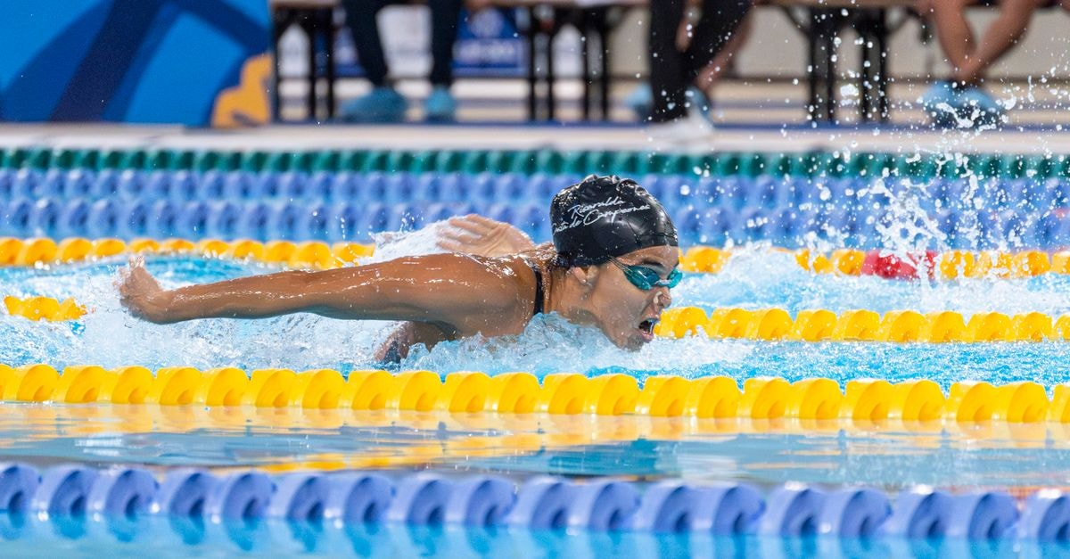 Kharun tops Dressel again as Stadden, Erisman and Grimes claim repeat titles at U.S. Swimming Nationals A swimmer in a race swimming the butterfly stroke during a competitive event.
