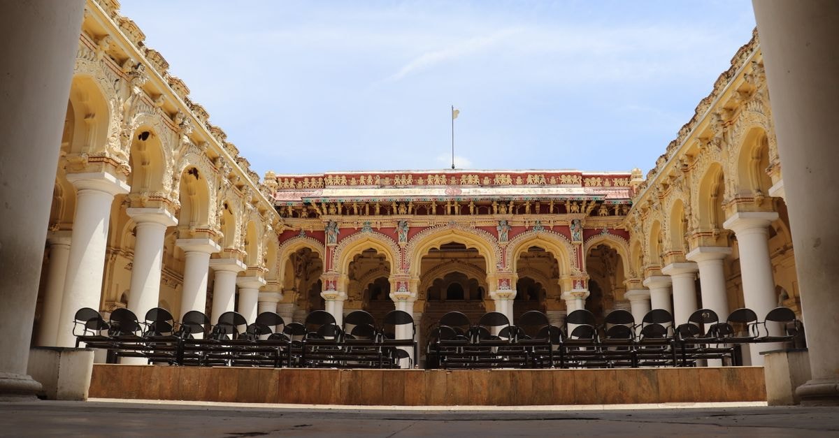 Beautiful view of Thirumalai Nayakkar Mahal's courtyard showcasing its ornate columns and architecture in Madurai, India.