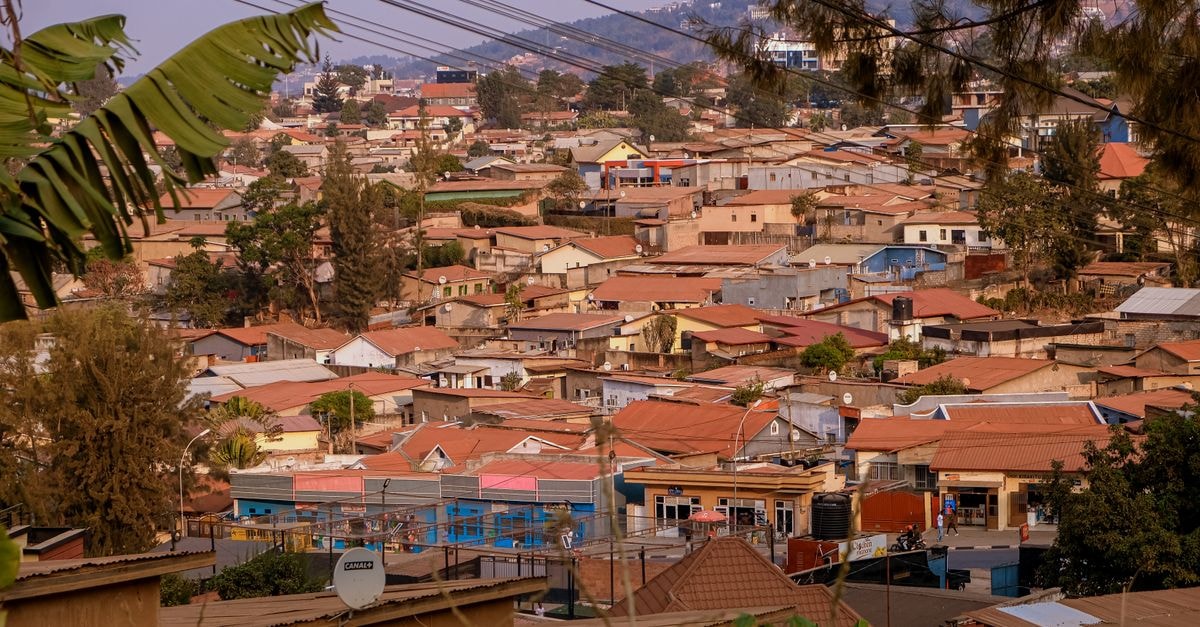 Byumba Travel Guide: Planning Tips, Costs and Things to Do Aerial view of Kigali's suburban rooftops with lush hills in the background, showcasing vibrant community life.