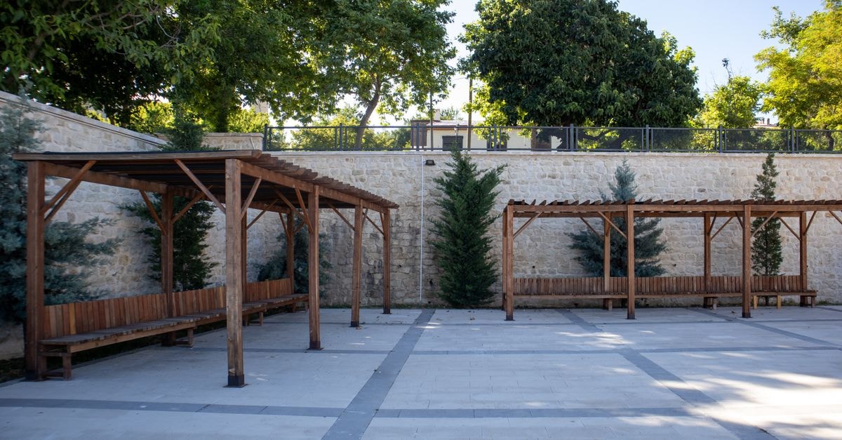 Courtyard in Dayton: A University-Area Stay with Leisure Highlights Peaceful outdoor courtyard with wooden pergolas and lush greenery in Elazığ, Türkiye.
