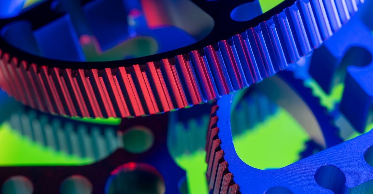 JBT Marel: Post-Marel Integration Quarter at a Market Price That Already Prices in Steady Execution Vibrant close-up image of colorful industrial gears, showcasing precision engineering.
