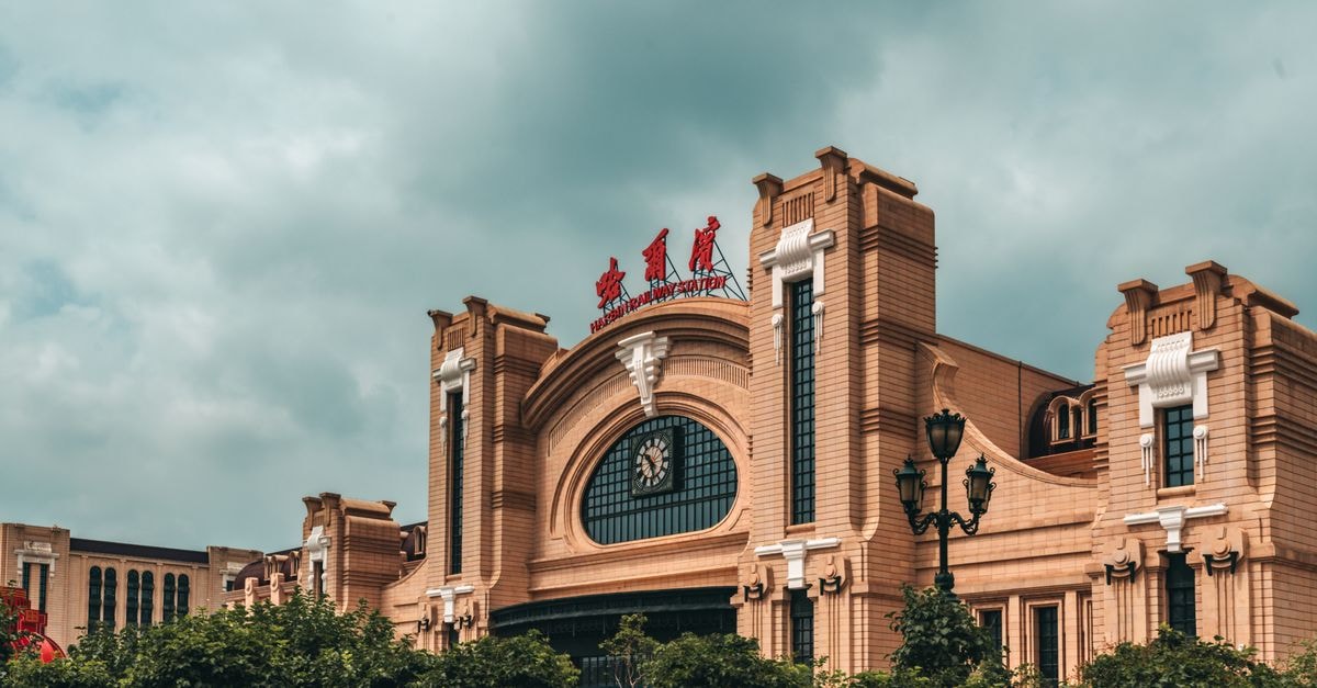 Longmen Hotel, Harbin: A Downtown Stay Steps from the Railway Station Exterior of Harbin Railway Station with overcast sky, capturing its grand architecture.