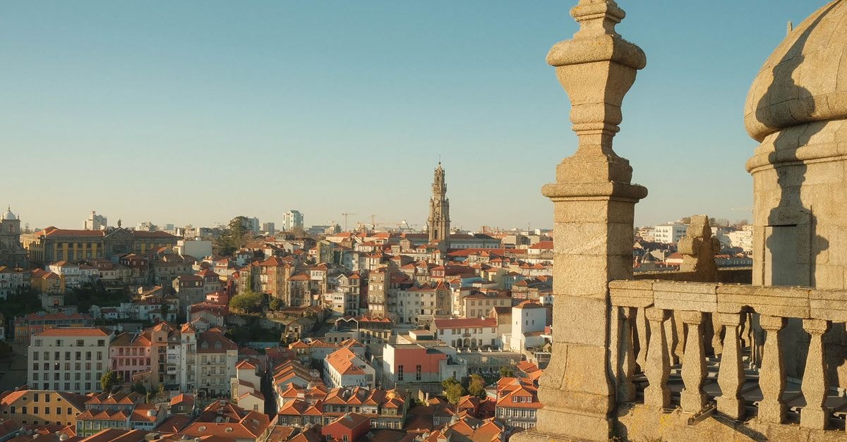 Montebelo Viseu Congress Hotel & Spa: A Panoramic Retreat in Central Portugal A picturesque view of Porto's cityscape featuring the iconic Clérigos Tower under a clear sky.