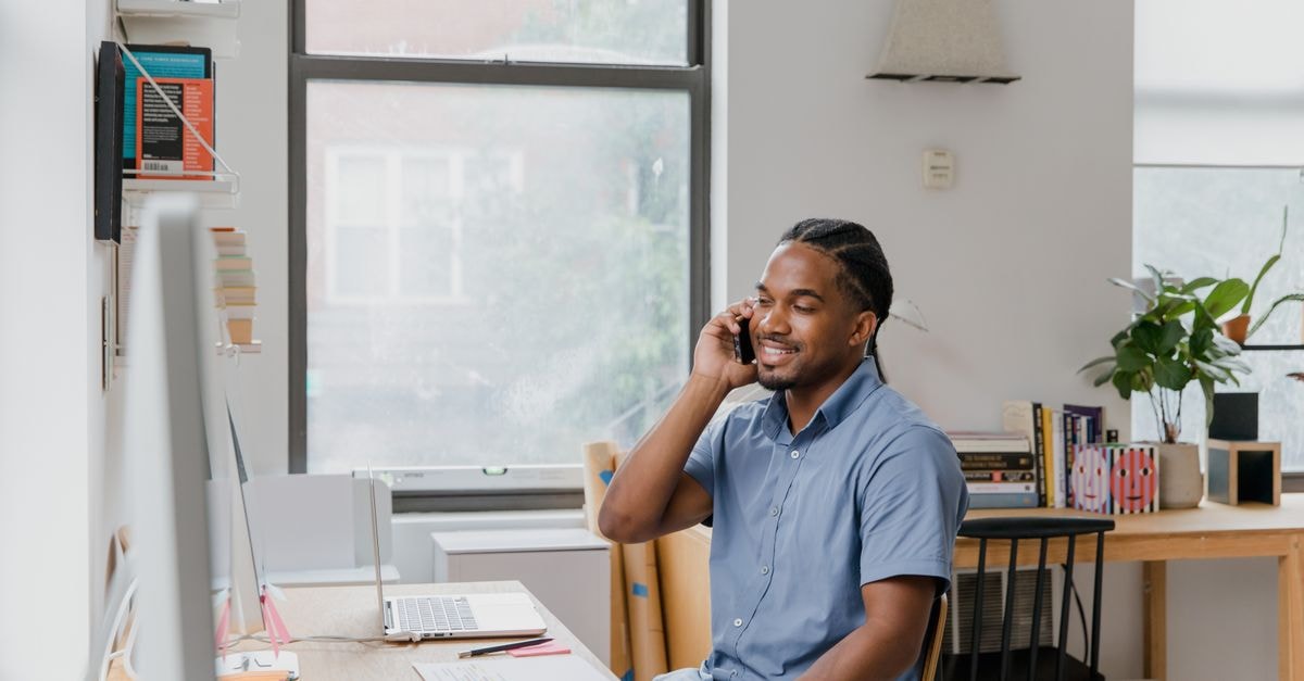 Trane’s bookings surge supports a stronger HVAC demand signal Adult man engaged in office work, speaking on phone, showcasing a professional environment.