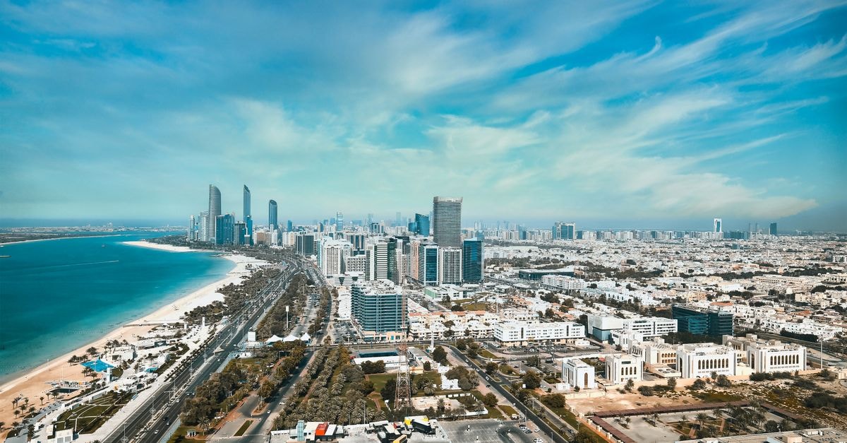 Al Mushrif Wedding Hall in Abu Dhabi: A Grand Setting in the City Center A breathtaking aerial view of Abu Dhabi's waterfront cityscape with modern high-rises and skyline.