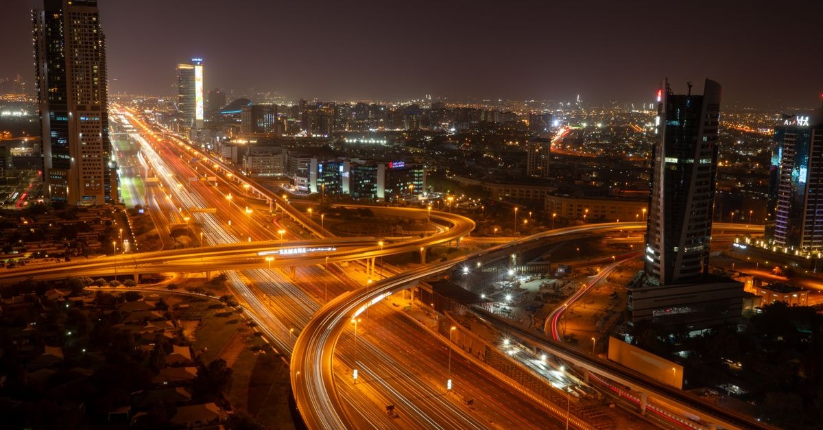 Studio One Hotel in Dubai: A Boutique Stay in Studio City A breathtaking view of Dubai's vibrant skyline and illuminated roads at night, showcasing modern urban architecture.