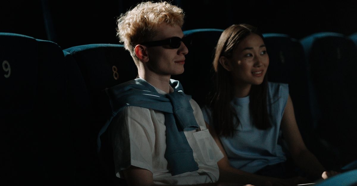 2026 Summer Box Office Sets All-Time Domestic Record at $4.76 Billion A couple watches a movie in a dark cinema, creating an intimate atmosphere.