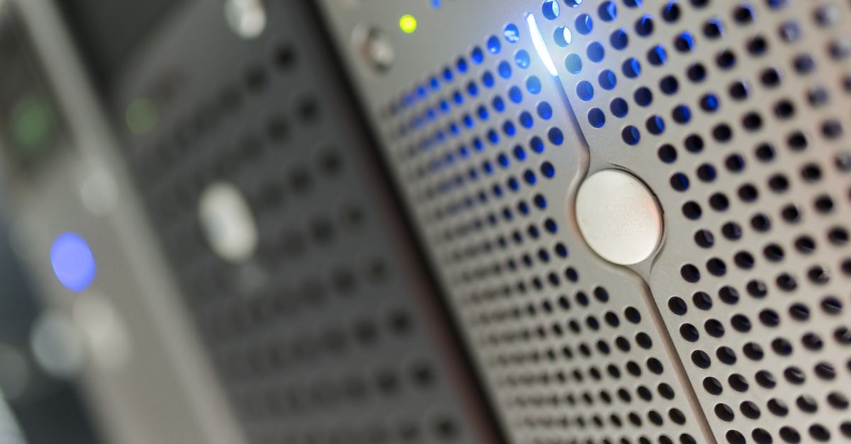 Focused detail of a modern server rack with blue LED indicators in a data center.