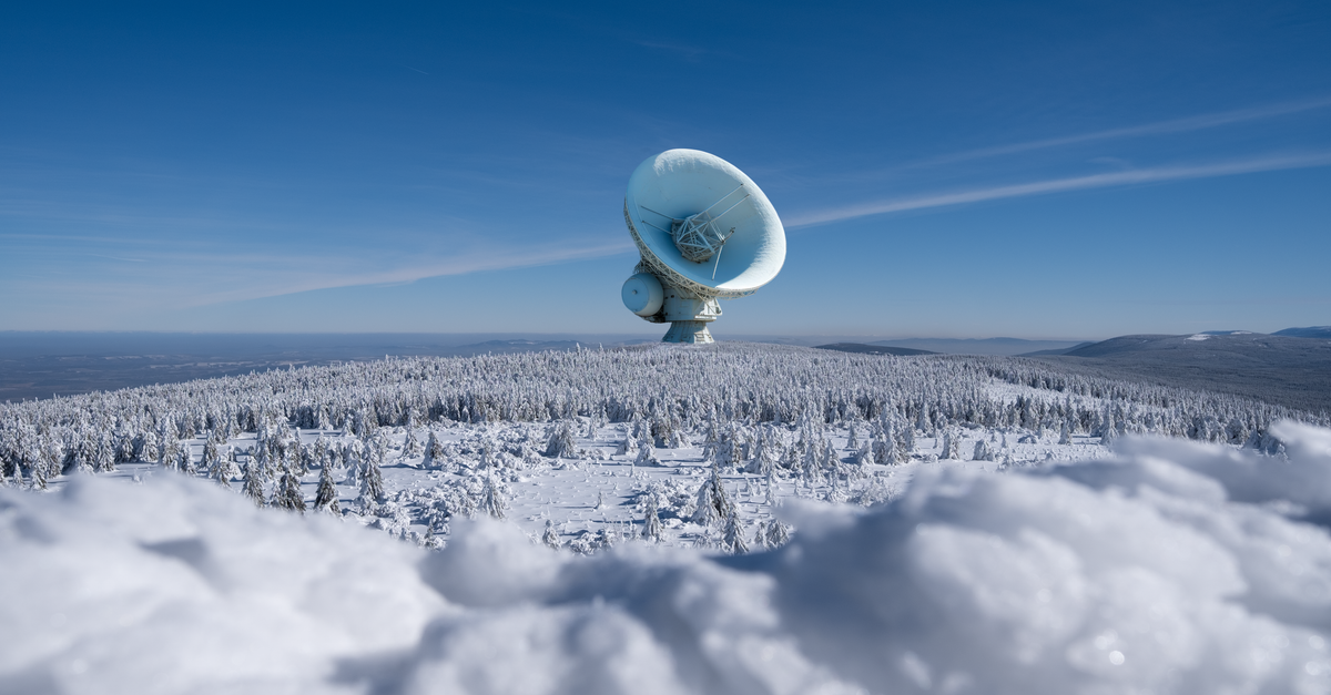 Google withdraws Earth AI satellite tool over deepfake misinformation concerns A large satellite dish observatory surrounded by snowy landscape and winter forest under a clear blue sky.
