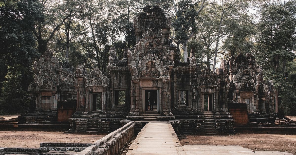 Siem Reap Travel Guide: Planning Tips, Costs and Things to Do Explore the serene beauty of an ancient Cambodian temple set amidst lush greenery in Siem Reap.