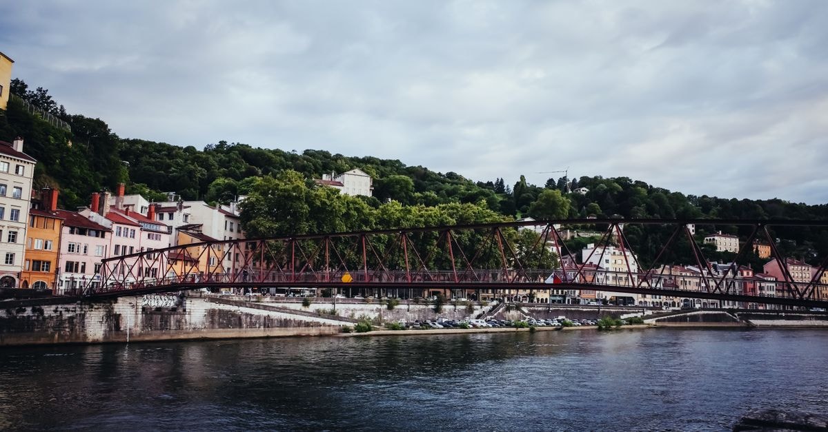 Picturesque view of a historic footbridge over the Saône River in Lyon, France.
