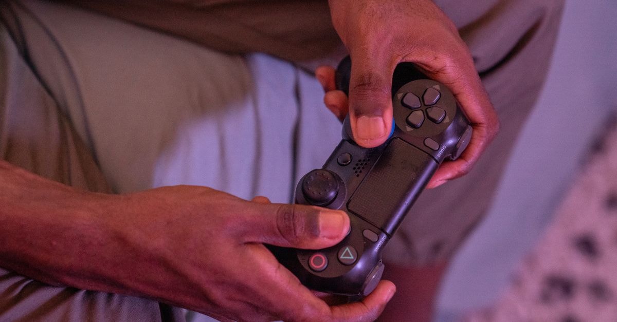 Valve sets Steam Frame pricing, opens lottery for SteamOS-based VR kit Hands gripping a game controller, engaged in a video game indoors.