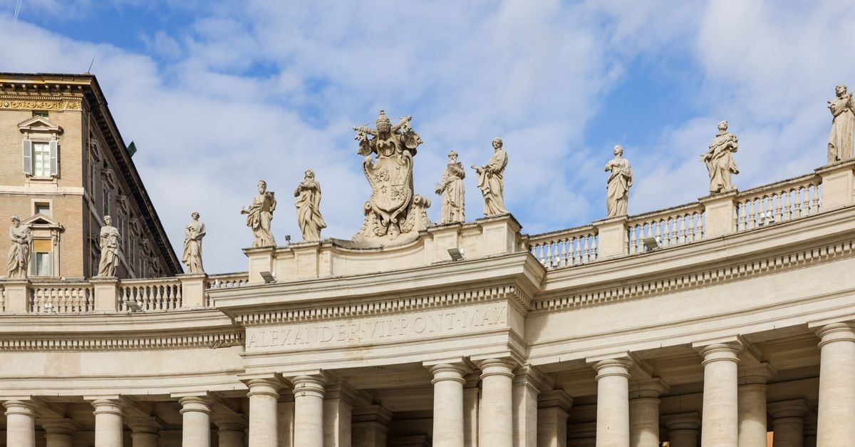 Vatican City Travel Guide: Planning Tips, Costs and Things to Do Historic colonnade and statues at St. Peter's Square under a blue sky, Vatican City.