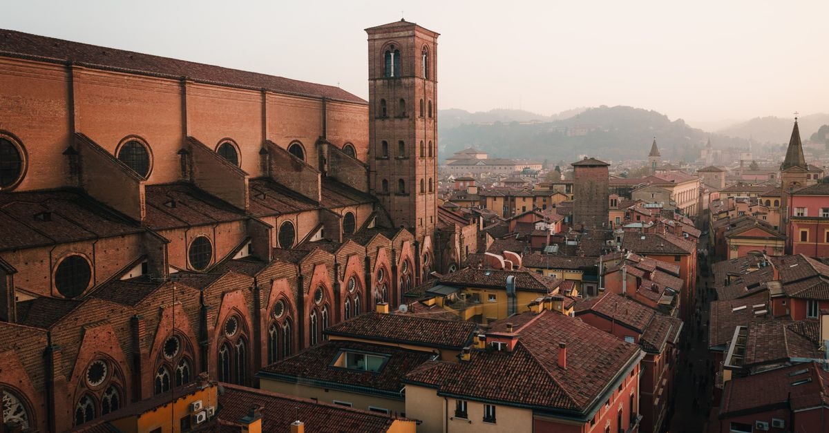 Art Hotel Commercianti, Bologna: A 12th-Century Palazzo Near Piazza Maggiore A breathtaking aerial view of Bologna's historic architecture at dusk, highlighting its rustic charm.