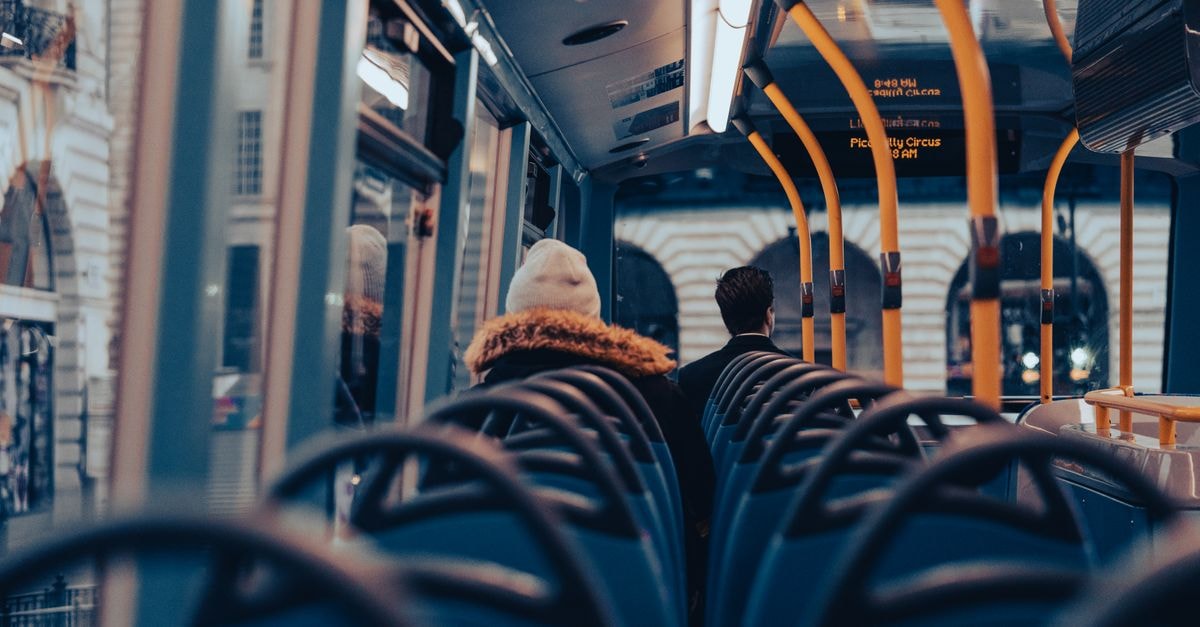 Passengers traveling on a city bus through London, capturing urban commuting life.