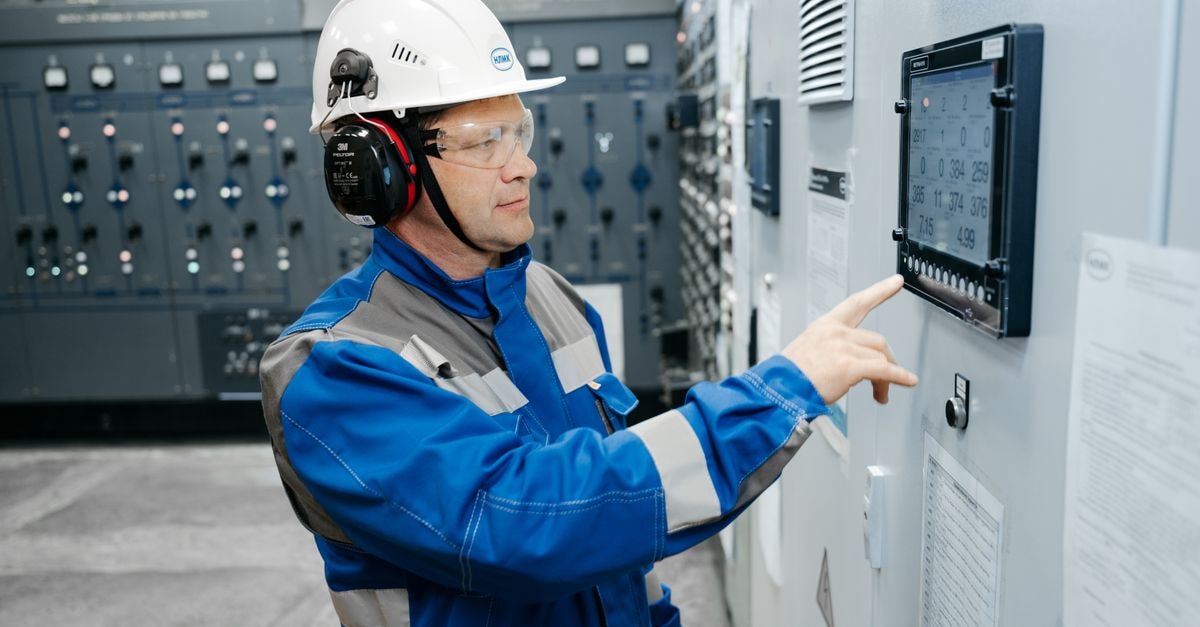 XPEL, Inc.: A Protective-Film Operator Pivoting to Vertical Manufacturing Technician in safety gear working at an industrial control panel indoors.