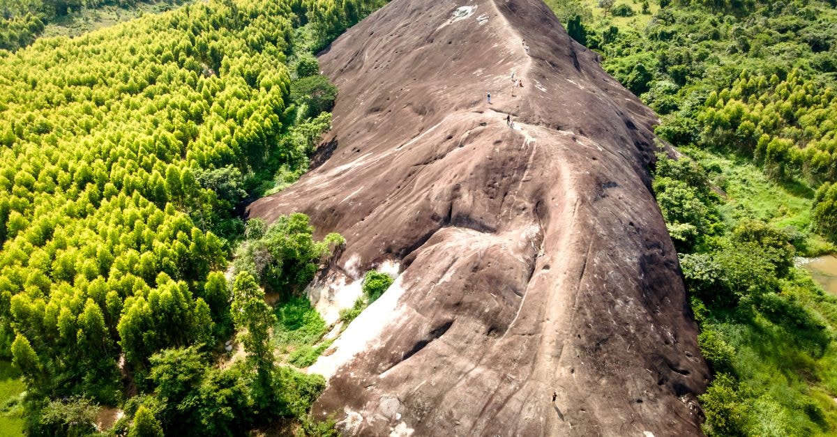 Kindu, DR Congo Travel Guide for Curious Explorers Drone shot of Mother Elephant Stone in lush green Vietnamese forest.