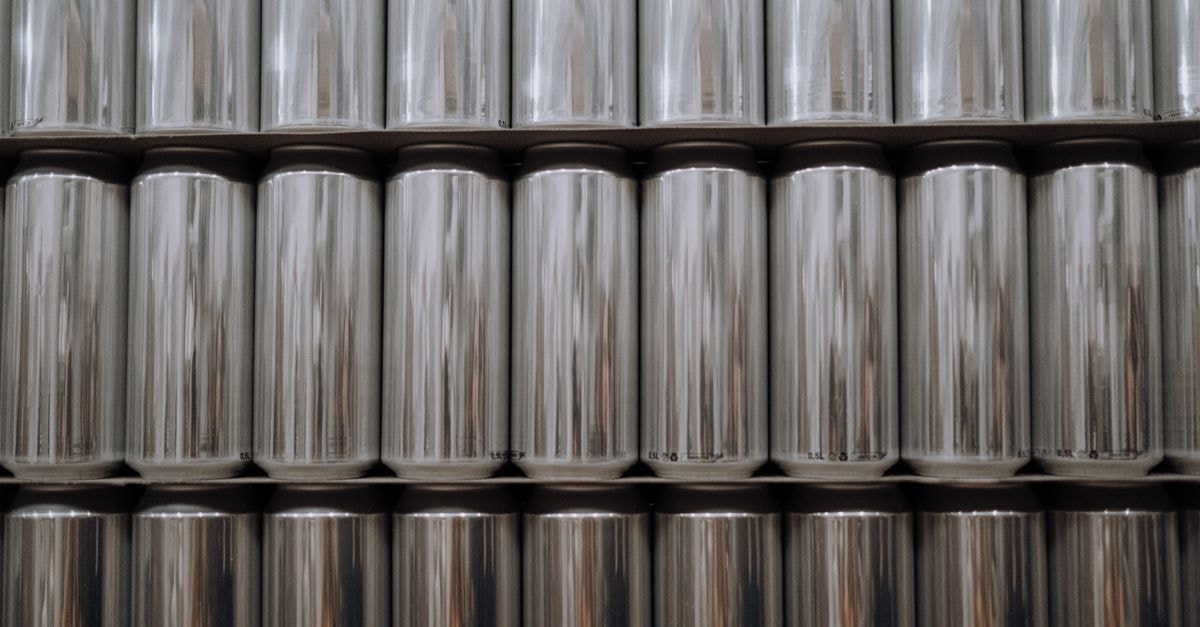 Century Aluminum: Commodity Cyclical, Not a Compounder A neatly organized stack of reflective aluminum beverage cans in an industrial setting.