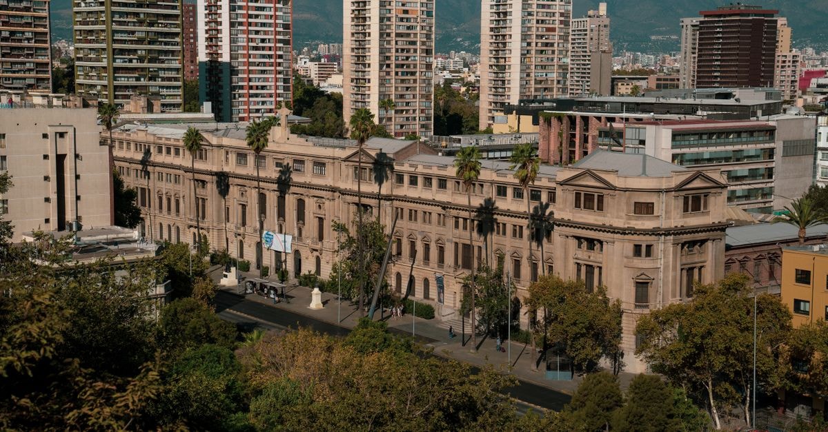 Mercure Hotel Santiago Centro in Santiago: A Downtown Stay Next to the Subway A historic building in Santiago, Chile with a backdrop of modern high-rise buildings.