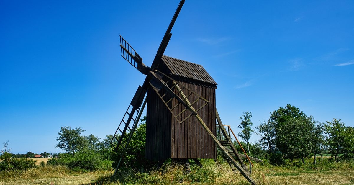 Kalmar Travel Guide: Planning Tips, Costs and Things to Do A picturesque traditional windmill under a clear blue sky in Stora Dalby, Sweden.