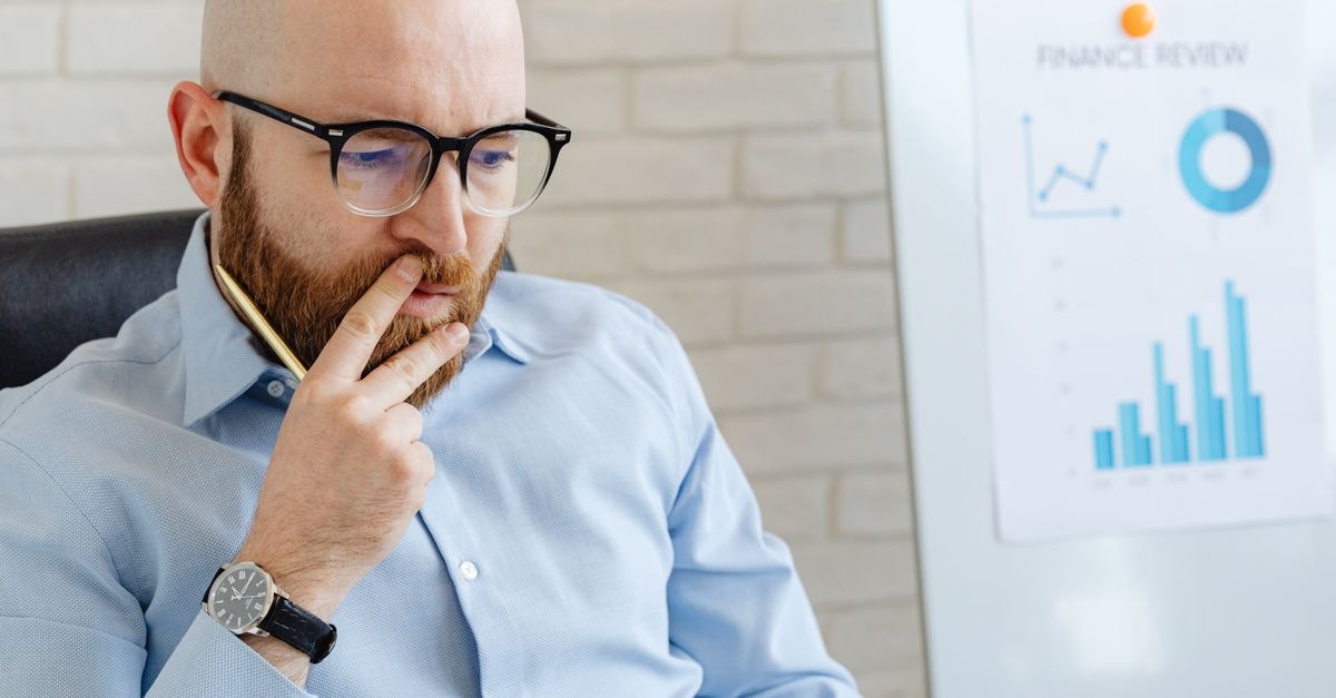 Analysts weigh whether Starbucks' same-store sales rebound can carry FY26 earnings Business analyst in a blue shirt analyzing financial charts on a whiteboard.
