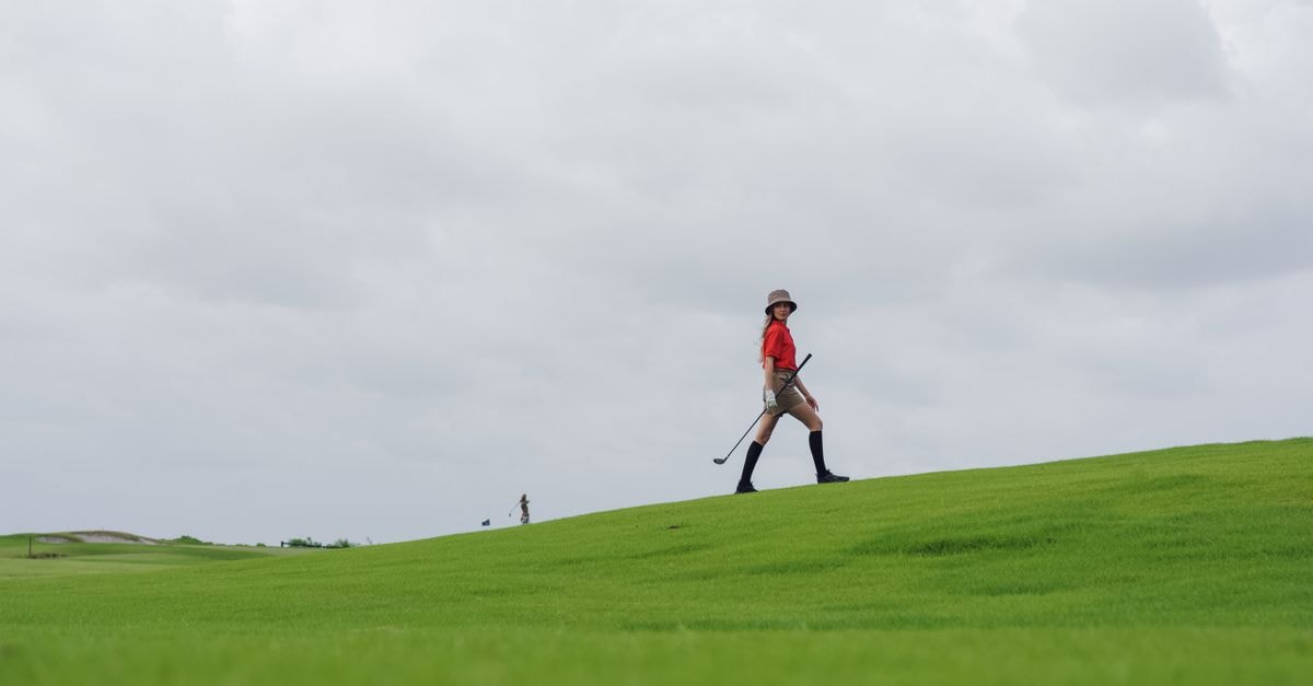 Noh takes three-shot lead into final round of Women's British Open Woman enjoying a leisurely walk on a golf course, carrying a club under a cloudy sky.