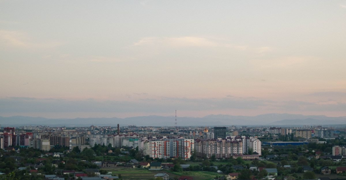 Aerial view of a cityscape at twilight showcasing an urban skyline with buildings and clear sky.