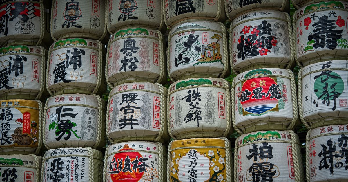 Kyoto Travel Guide: Temples, Bamboo, Markets and Station-Area Stays Traditional sake barrels with Japanese kanji, Kyoto temple display.