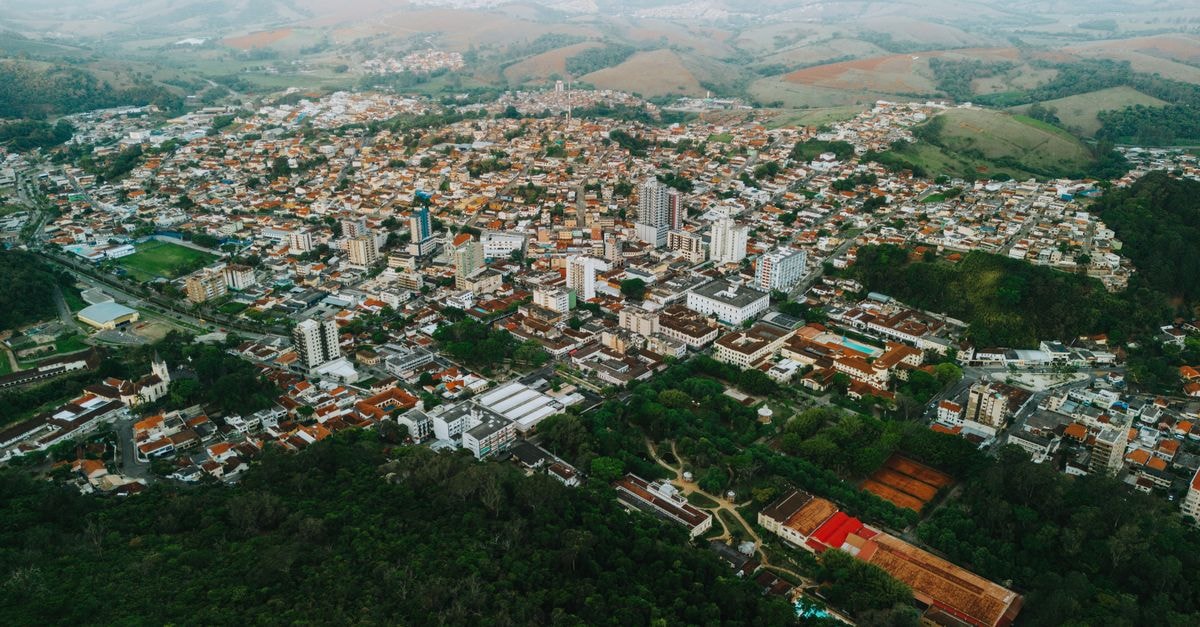 City Hotel in Caxias do Sul: Central Stay with Breakfast Included Stunning aerial view of Caxambu, Brazil, showcasing urban landscape and surrounding hills.
