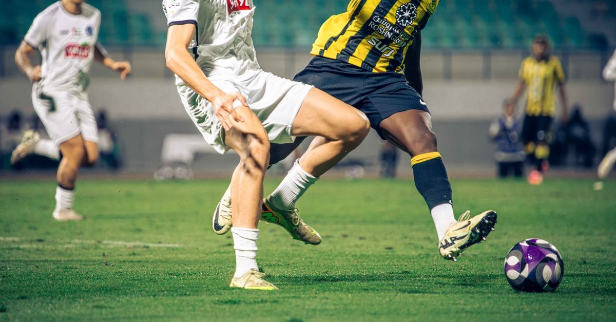Dynamic soccer action capturing players in motion during a competitive match.