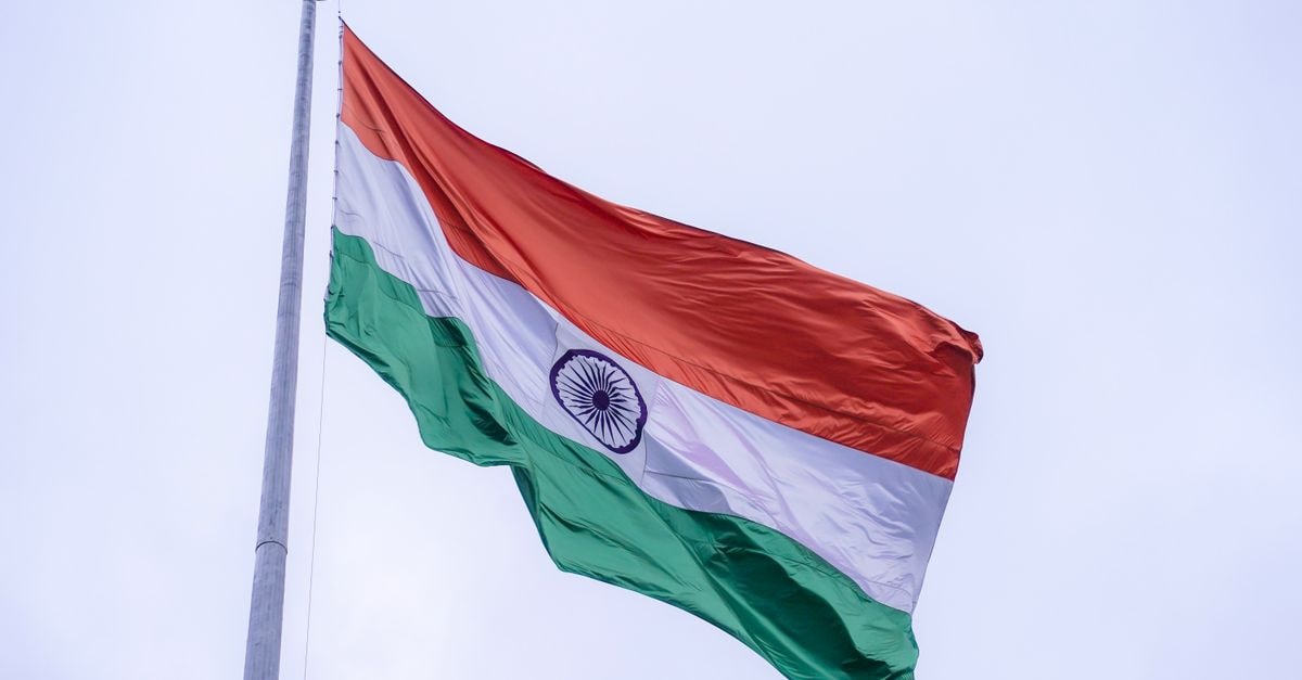 Hotel Solas in Mataram: A Quiet Gang XIV Pocket of the City The Indian national flag proudly waves on a flagpole against a clear blue sky in Noida, India.