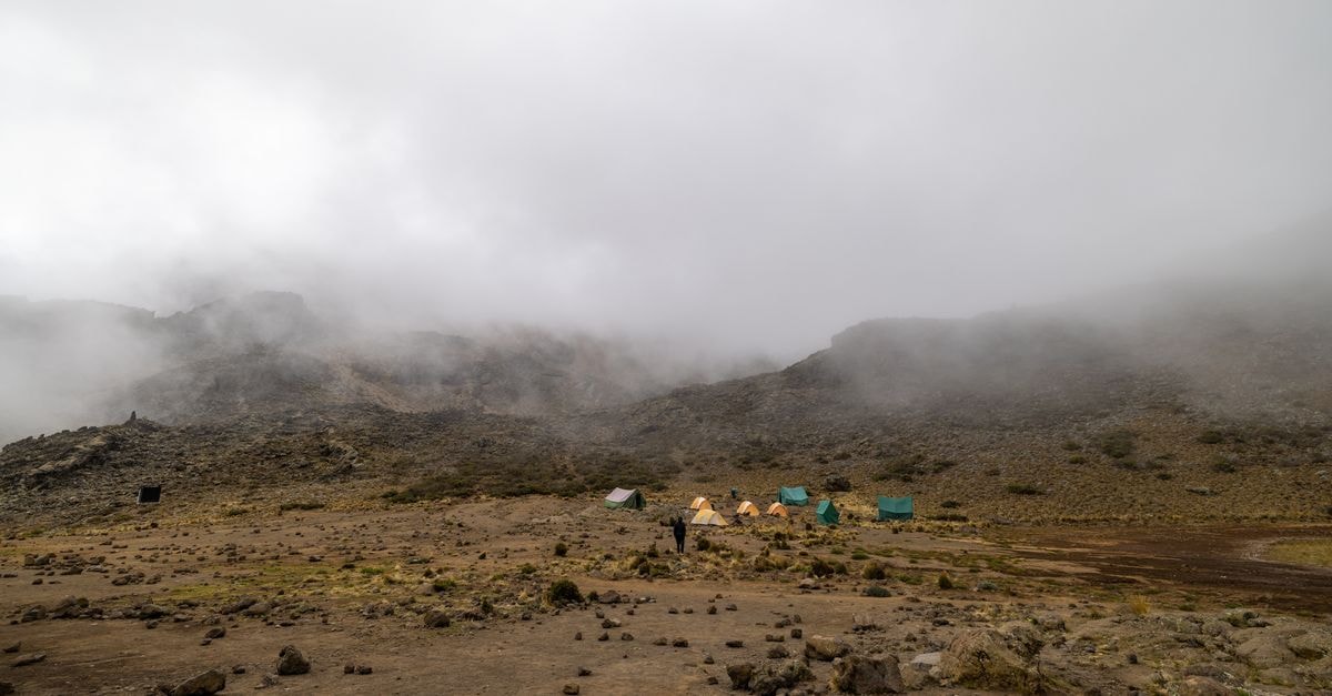 Camping amidst foggy landscapes on Mount Kilimanjaro's Tanga Region, Tanzania.