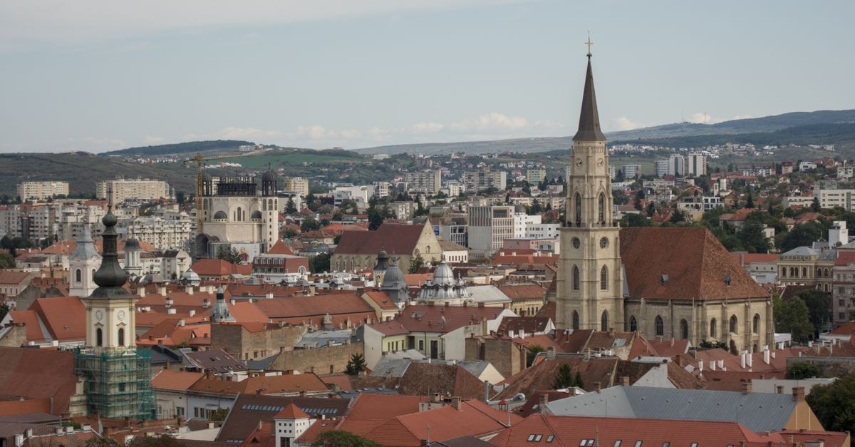 Cluj-Napoca travel guide: getting around and soaking up Transylvania's heart Aerial view of Cluj-Napoca showcasing churches and cityscape.