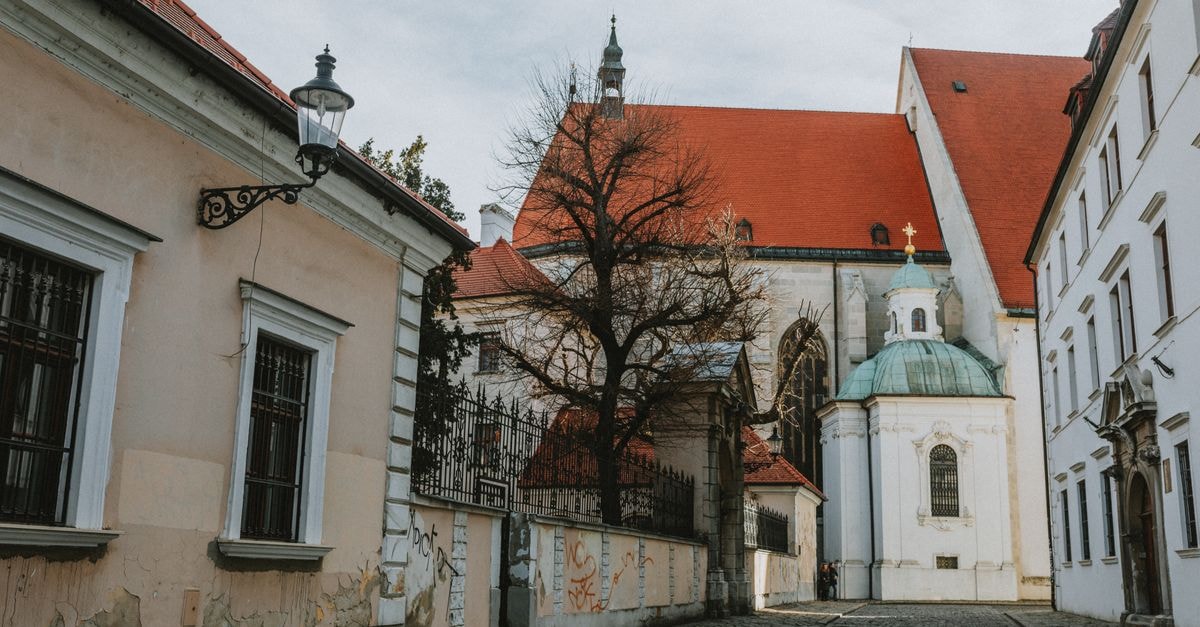 Historic street view featuring St. Martin's Cathedral in Bratislava, showcasing Gothic architecture.