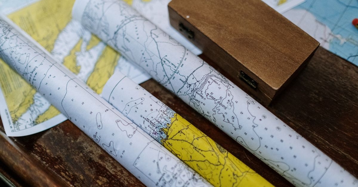 Narsingdi Travel Guide: Heritage, Flavor, and Easy Routes Close-up of rolled nautical maps on a wooden table, perfect for navigation themes.