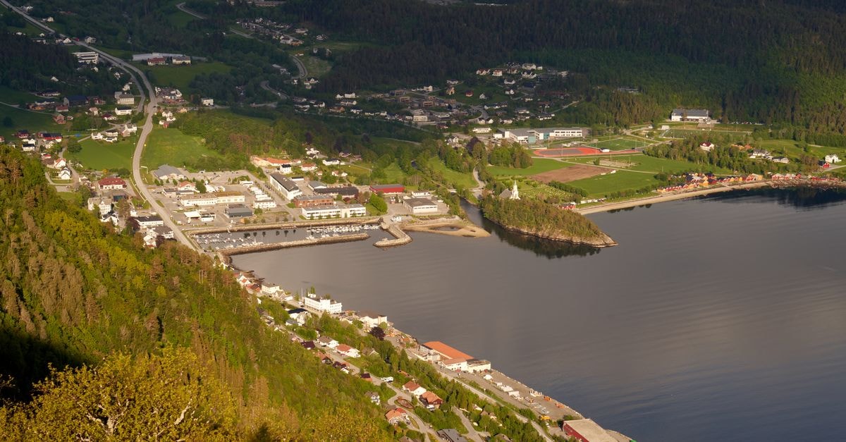 Kolda Travel Guide: Planning Tips, Costs and Things to Do A picturesque aerial shot of a lush green lakeside town with buildings and roads.