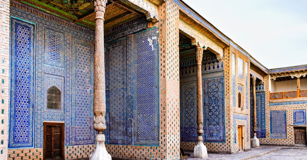 Andijan Travel Guide: Fergana Valley Charm Beyond the Silk Road A detailed view of the beautiful and ornate facade of Toshhovli Palace in Khiva, showcasing traditional Uzbek architecture.