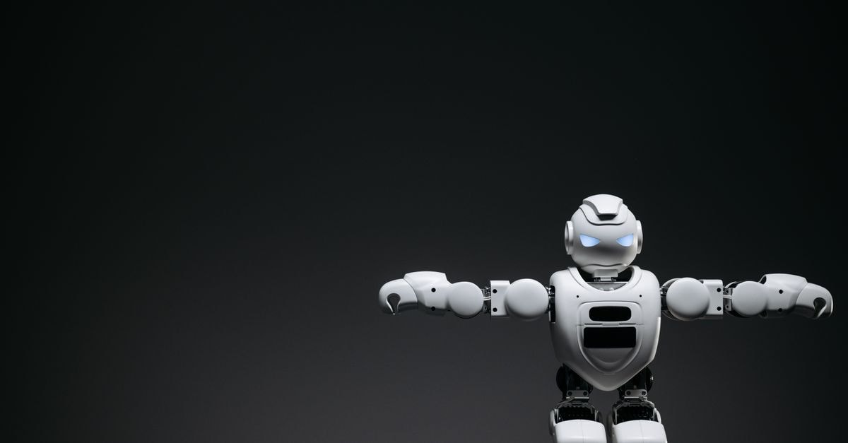 Google rolls out Gemini Robotics ER 2 as BYD readies first humanoid robots for August Studio shot of a humanoid robot with glowing eyes against a dark background, offering ample copyspace.