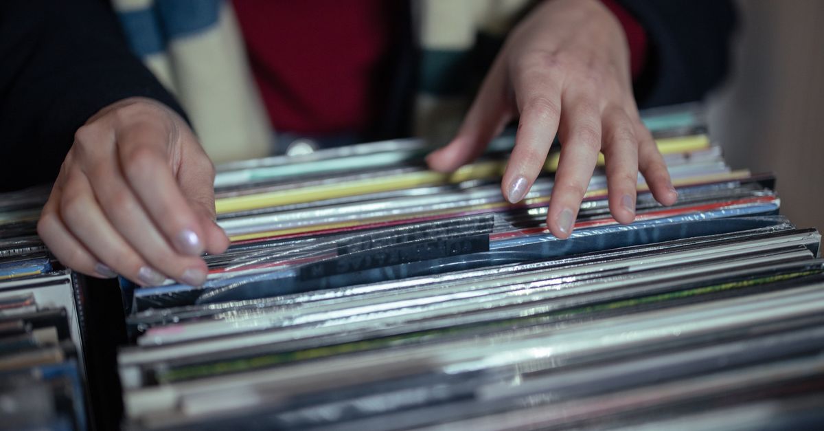 Gracie Abrams debuts atop UK Albums chart as South Korea's rise to global music prominence is examined Hands browsing through a vintage vinyl record collection in a music store.