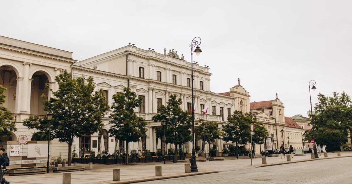 Bialystok Travel Guide: Planning Tips, Costs and Things to Do A view of Polonia House on a quiet street in Warsaw, Poland, showcasing historic architecture.
