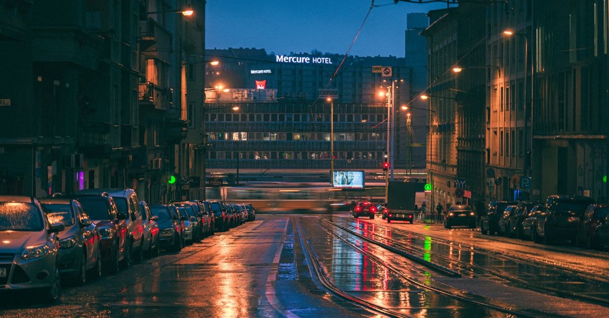 Mercure Hotel, Aden: Seafront Stay on the Gulf of Aden Rain-soaked street in Budapest captures the illuminated Mercure Hotel and city lights at night.