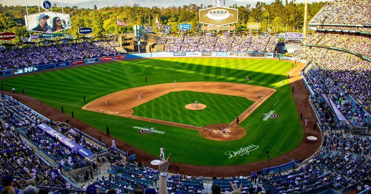 Dodgers close out Braves in NLDS Game 4 to advance to NLCS A lively baseball game at Los Angeles' iconic Dodger Stadium, capturing the vibrant atmosphere and full crowd.