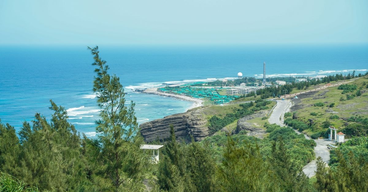Explore the beautiful coastal landscape of Ly Son Island with lush greenery and clear blue waters.