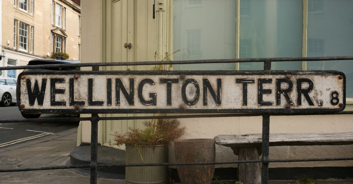 Cheltenham, England: A Slow Travel Guide to a Regency Town Rustic street sign for Wellington Terrace in Bristol, England showing an old-world charm.