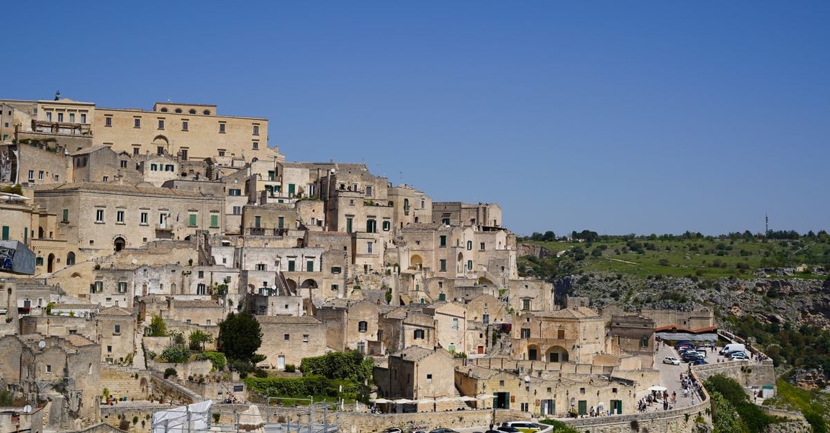 Locanda di San Martino in Matera: A Cave-House Stay in the Sassi View of the ancient stone city of Matera in Basilicata, Italy under a clear blue sky.