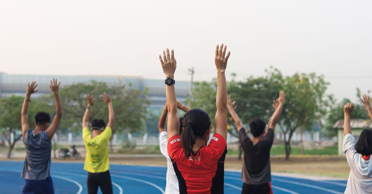 Hilton Mandalay, Mandalay: Garden Retreat Facing Mandalay Hill A group of adults exercising on a blue running track in Mandalay, Myanmar.