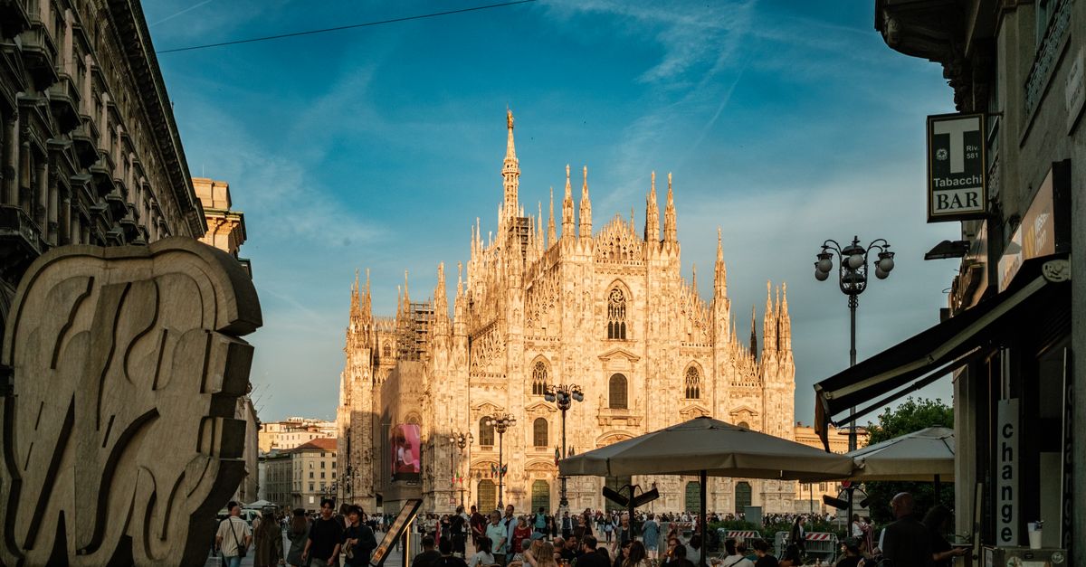 Milan in July 2026: A Heat-Smart Travel Guide Enjoy a lively evening scene at the Duomo di Milano with bustling crowds and beautiful architecture.
