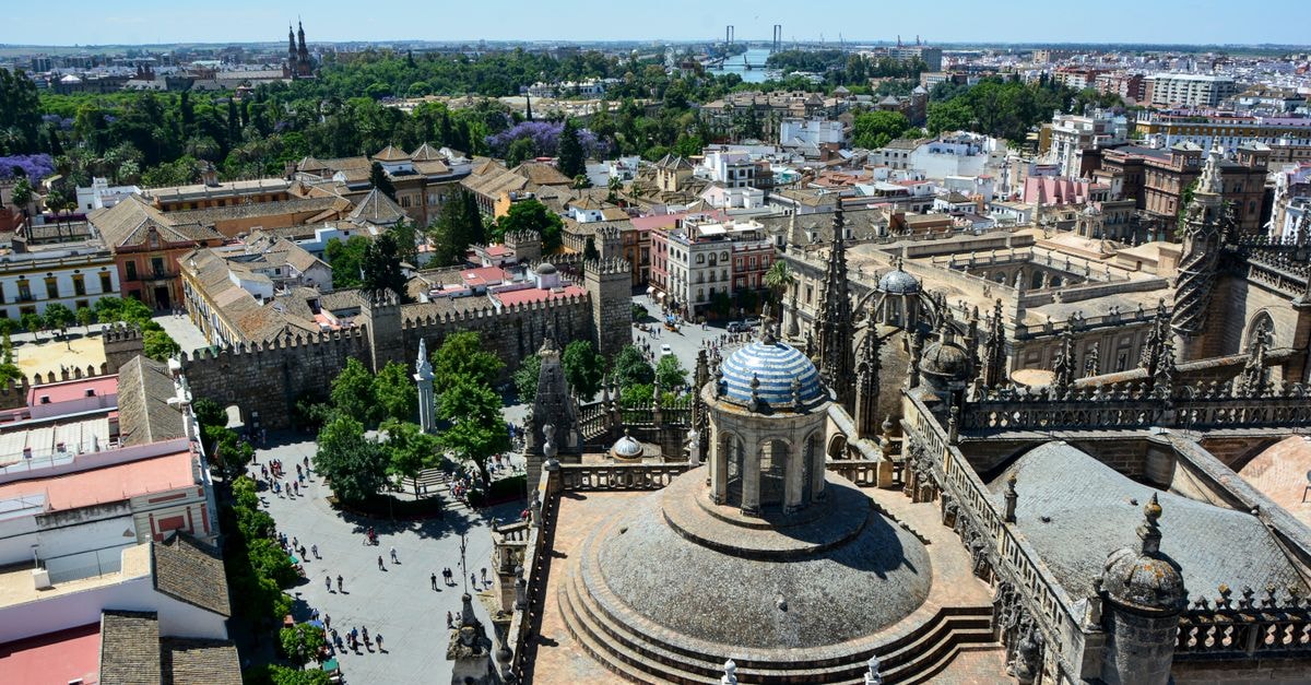 Petit Palace Marqués Santa Ana: Historic Centre Boutique Base in Seville Stunning aerial view of Seville Cathedral with the cityscape of Seville, Spain on a sunny day.