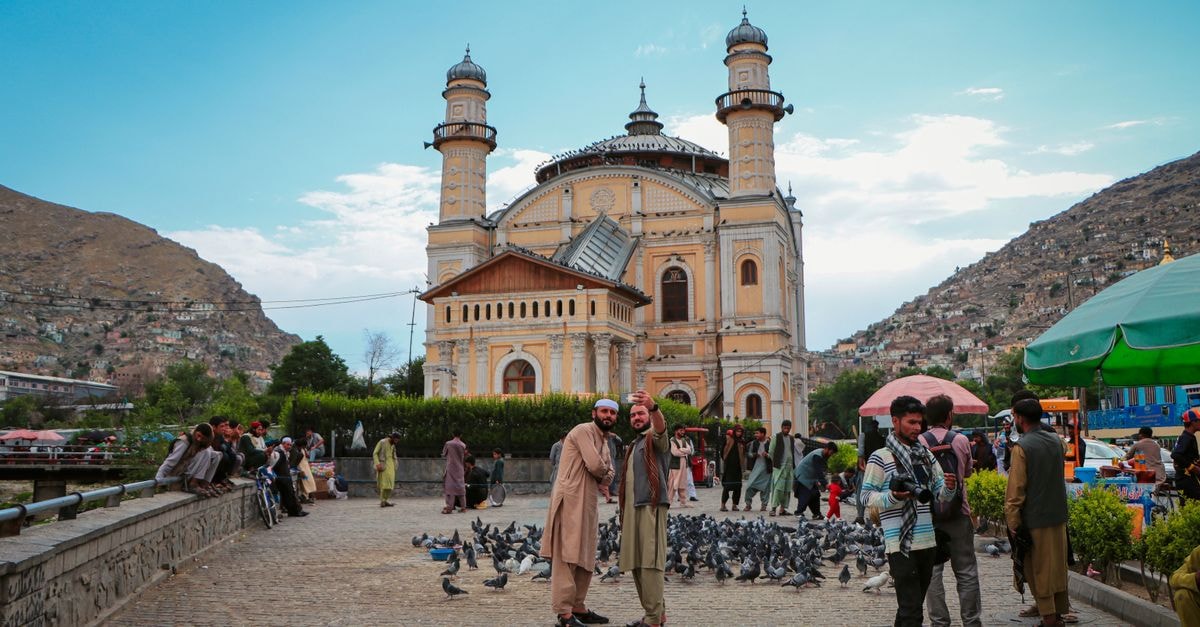 Kabul Taj Hotel in Kabul: A Practical Stop on Gawharshad Begum Avenue Tourists capturing moments at the historic Shah-Do Shamshira Mosque in vibrant Kabul, Afghanistan.